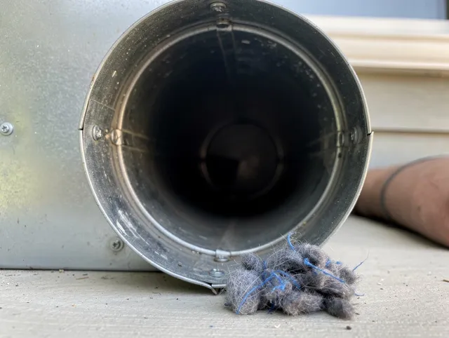 Millbury Dryer Vent Cleaning technician using specialized equipment to clear severe dryer vent blockage in Millbury